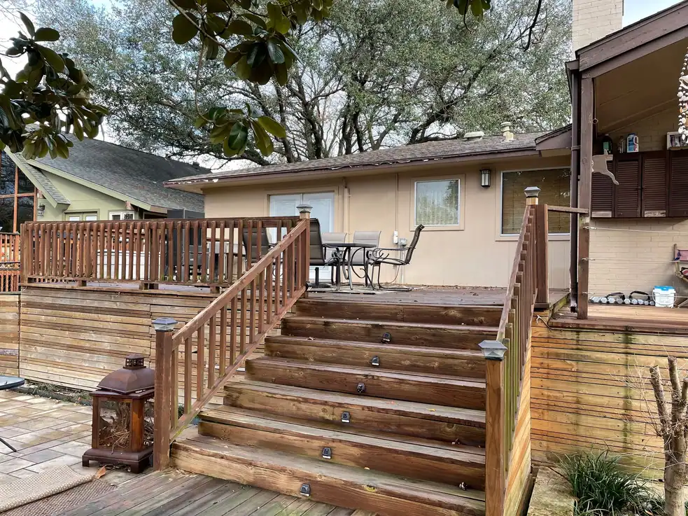 Finished raised wood deck with stairs and railings