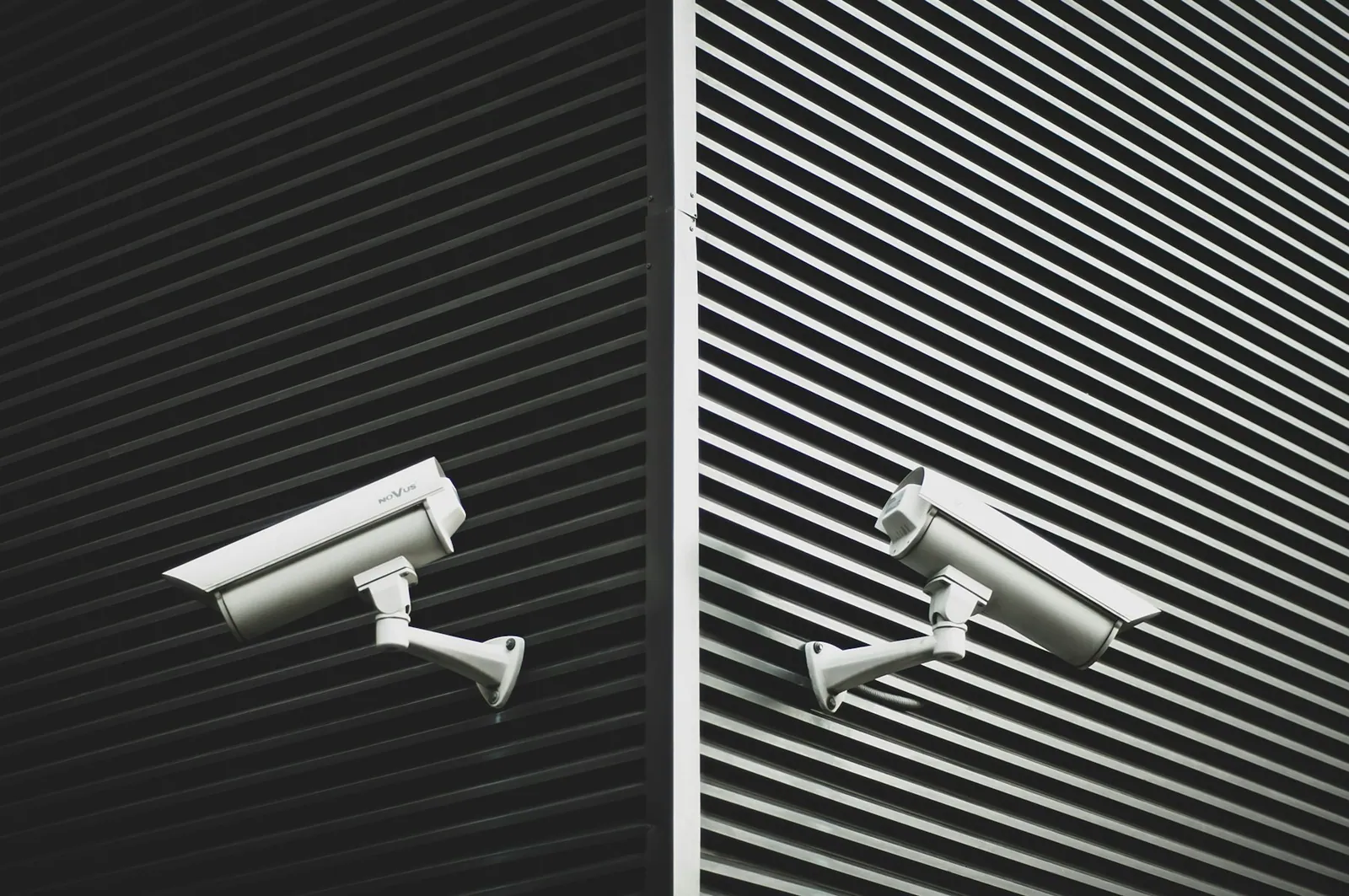 Two security cameras mounted on a building wall