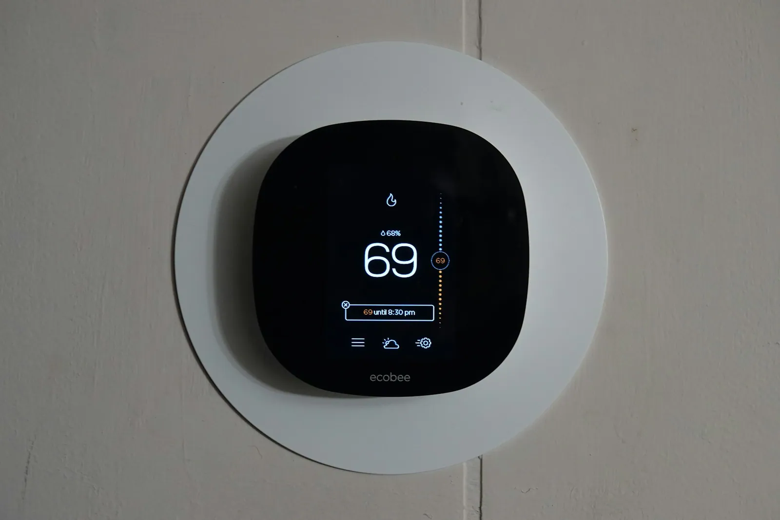 Wall-mounted touch control panel showing building controls