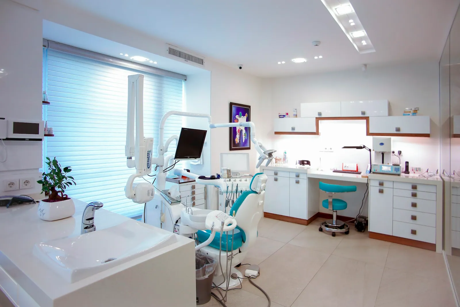 Modern dental operatory with patient chair and overhead light