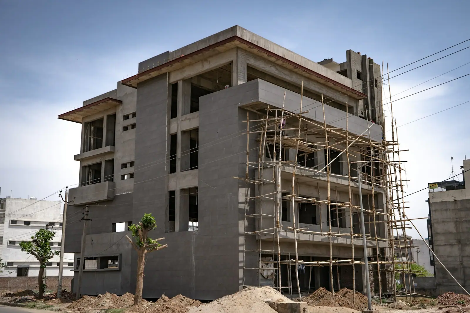 Multi-story residential building under construction with scaffolding