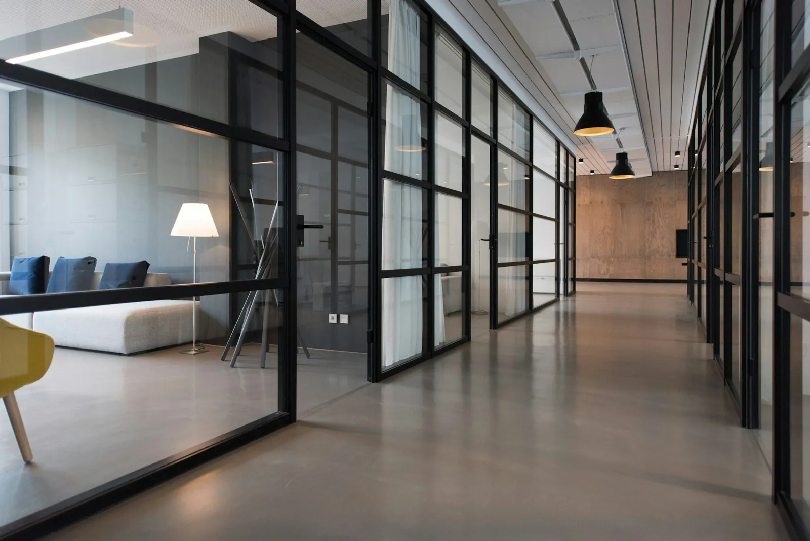 Office hallway lined with glass-front offices