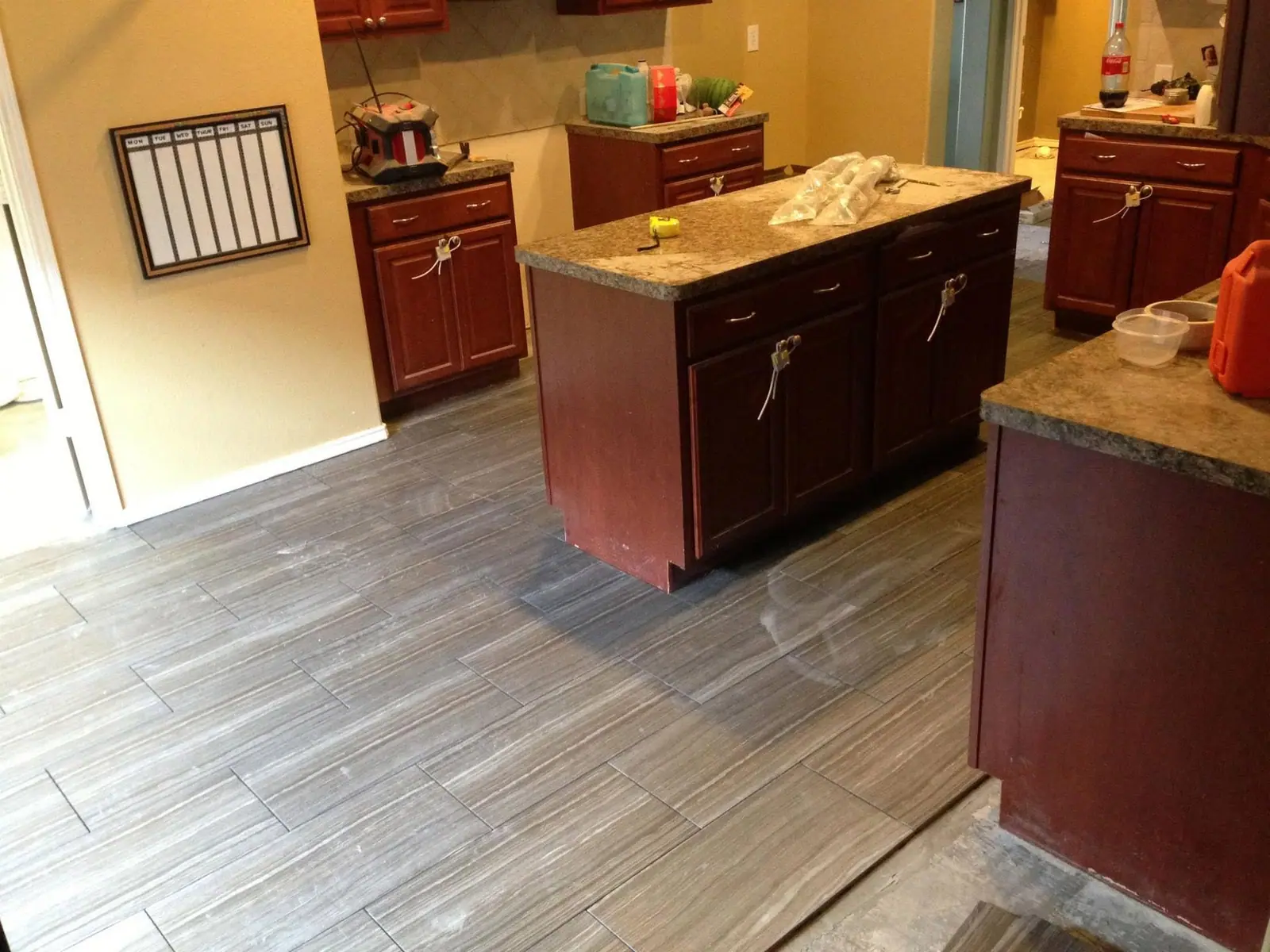 Finished kitchen with dark cabinets and a granite island