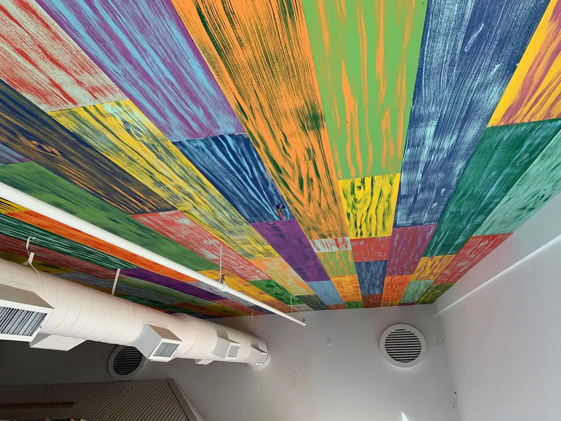 Restaurant with a multicolor painted slat ceiling