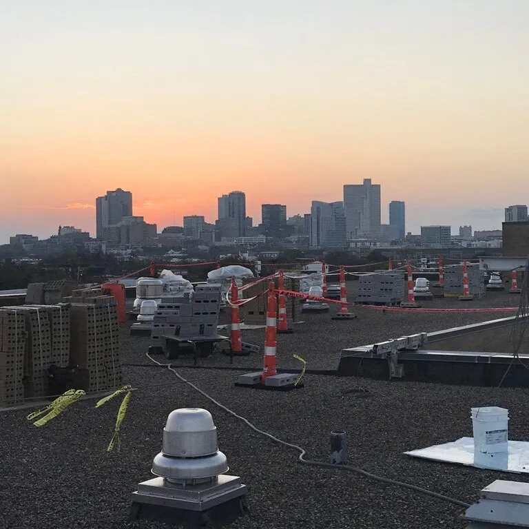 Commercial rooftop at dusk with the Dallas skyline in the distance