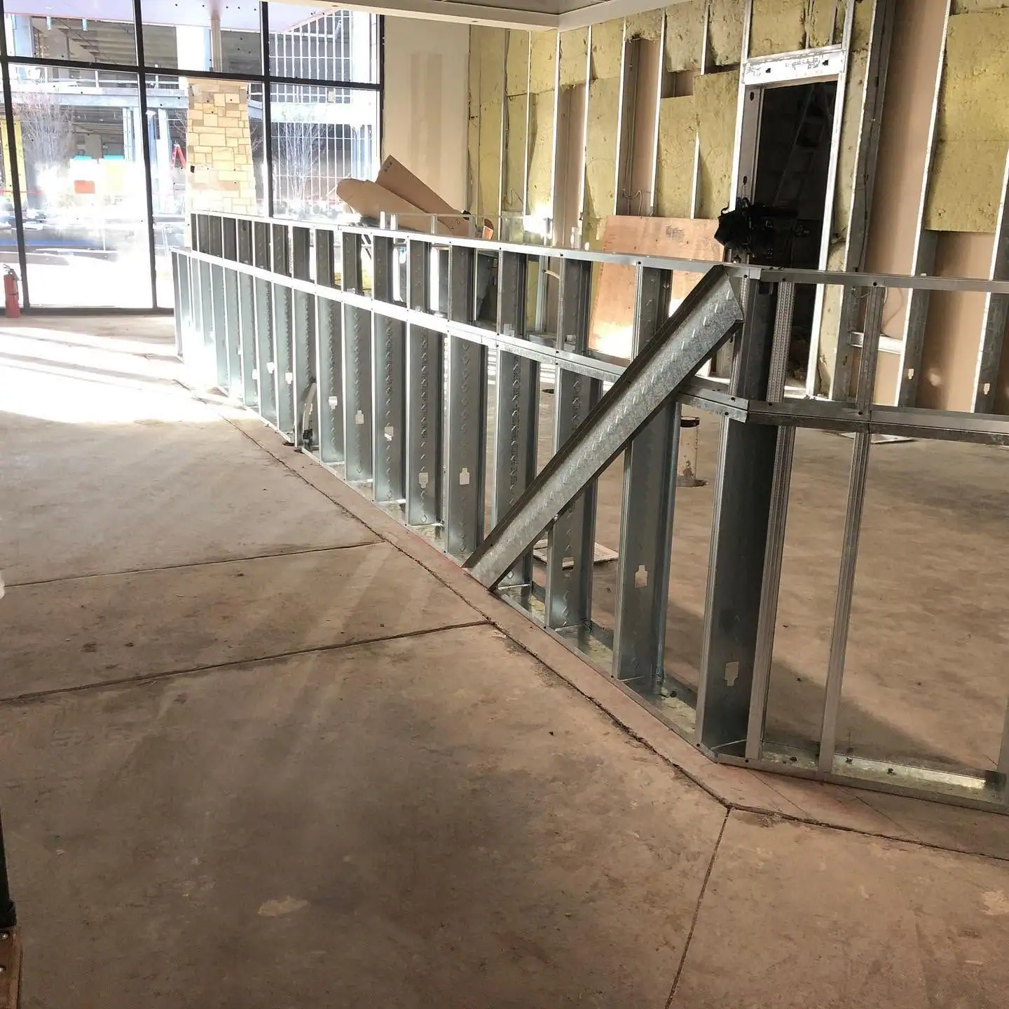 Metal stud walls framed inside a glass-front retail space